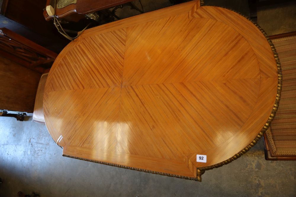 A parcel gilt satinwood centre table, width 113cm height 62cm, and a pair of Edwardian satinwood salon chairs